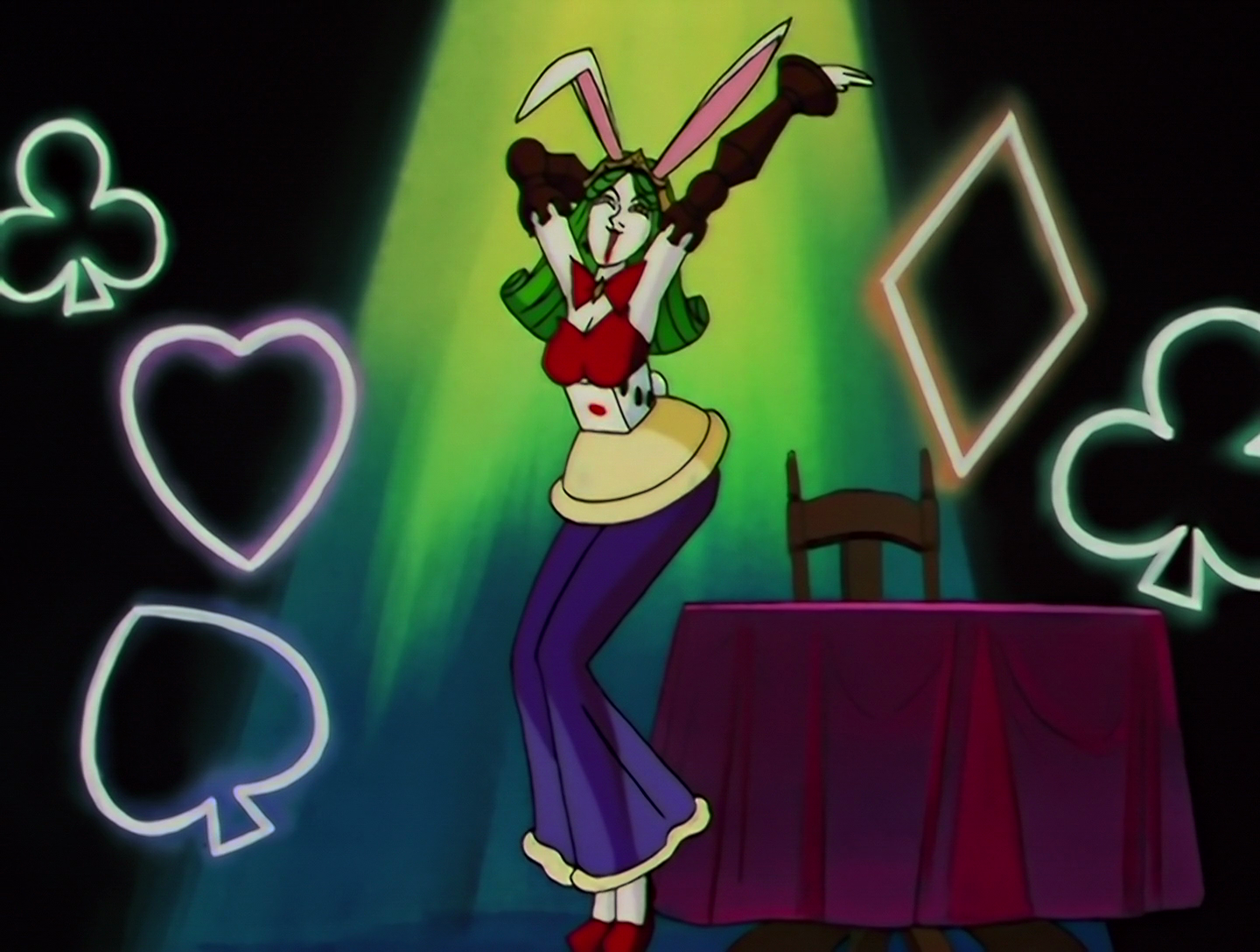 A longer shot of U-Ikasaman, who’s now shed the queen outfit. She now has white rabbit ears, and wears a red top with a long purple skirt. This also incorporates a large dice around her waist, and the white base of a game piece below that. She’s wearing large chess pieces as sleeves. She’s also evidently having a lot of fun and I love that for her.